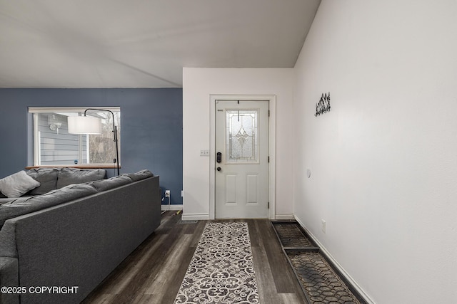 foyer featuring dark wood finished floors and baseboards