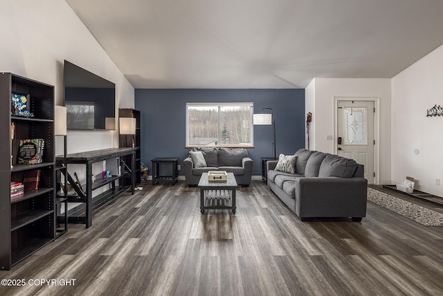 living area with baseboards and dark wood-type flooring