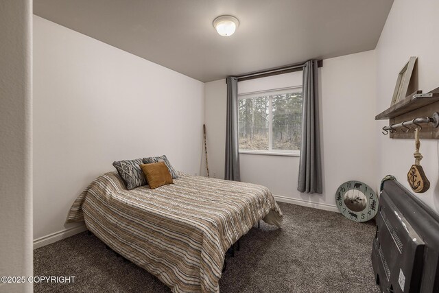 carpeted bedroom featuring baseboards