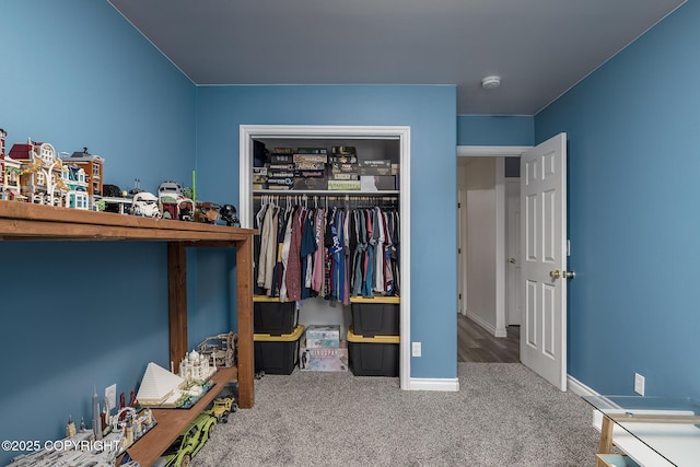 carpeted bedroom with baseboards and a closet