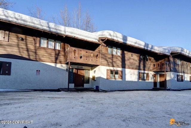 back of property featuring stucco siding