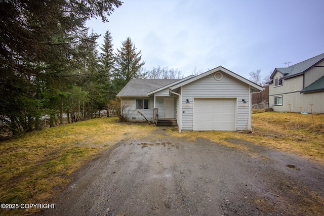 view of front of home with a garage, fence, and aphalt driveway