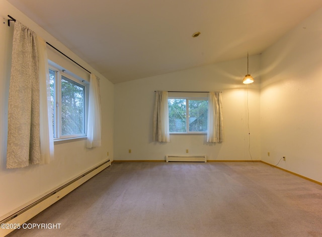 empty room with a baseboard heating unit, a wealth of natural light, lofted ceiling, and baseboard heating