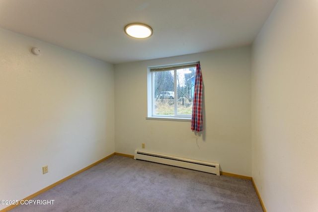 carpeted spare room with a baseboard heating unit and baseboards