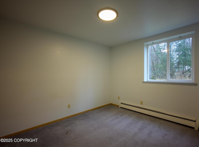 carpeted spare room with a baseboard heating unit and baseboards