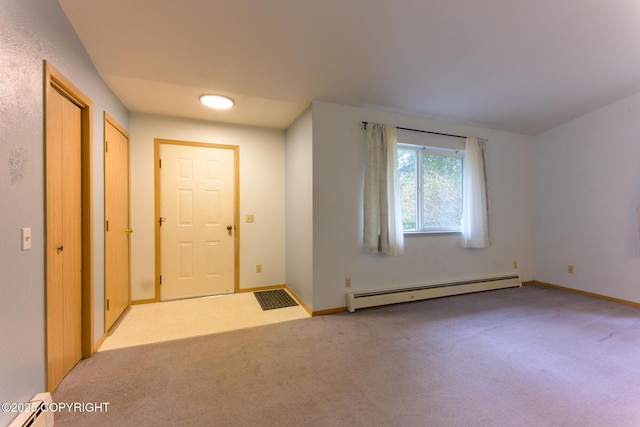 entrance foyer featuring baseboard heating, a baseboard radiator, carpet flooring, and baseboards