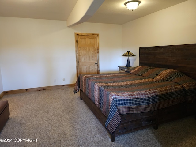 bedroom featuring carpet floors and baseboards