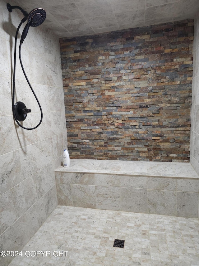 bathroom with a tile shower