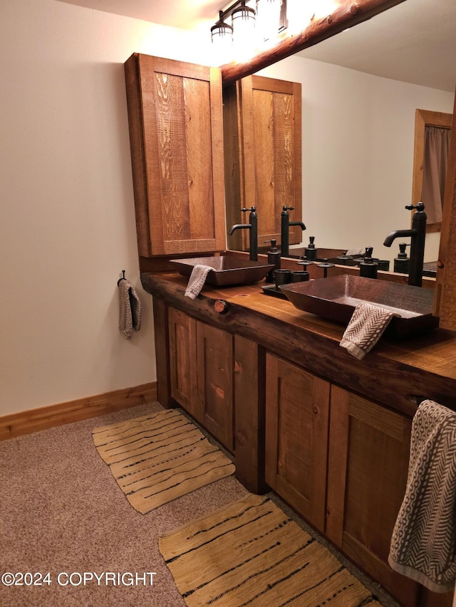 interior space with a sink and baseboards