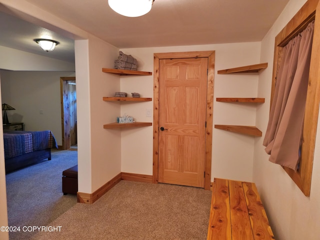 hall with carpet floors and baseboards