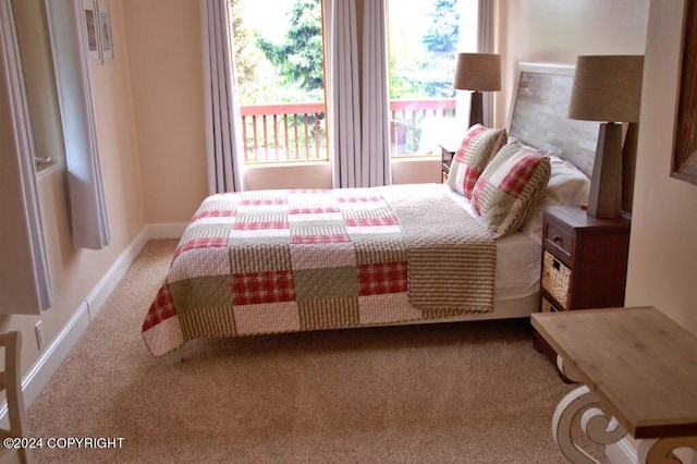 carpeted bedroom featuring baseboards