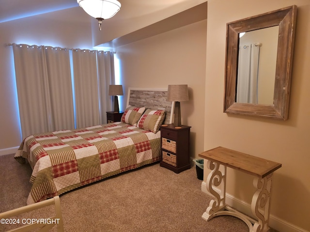 carpeted bedroom featuring baseboards