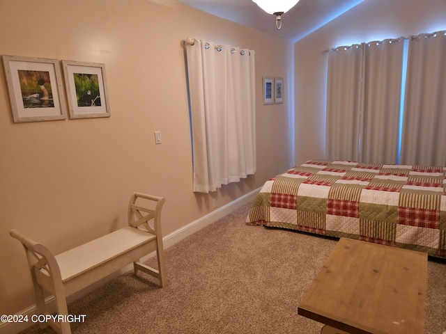 bedroom featuring carpet floors, baseboards, and lofted ceiling