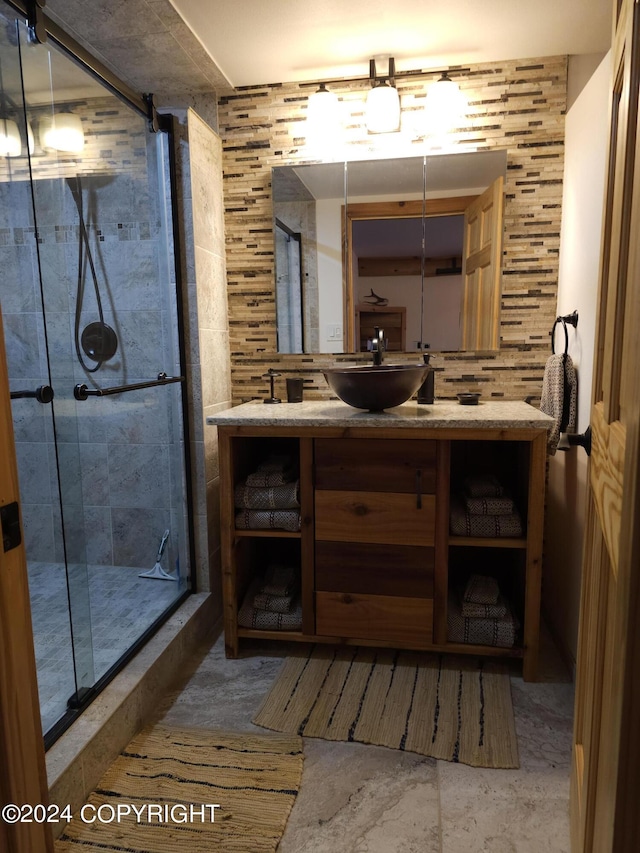 full bath featuring a stall shower, backsplash, and vanity