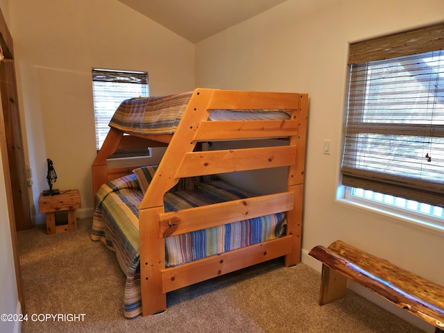 bedroom with carpet and vaulted ceiling