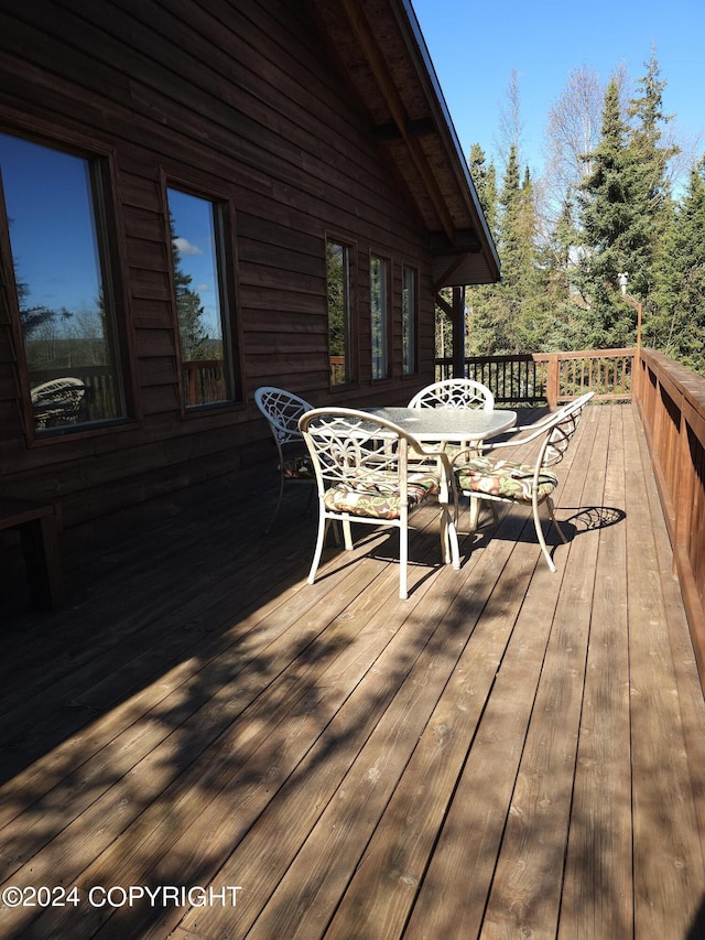 wooden terrace with outdoor dining space