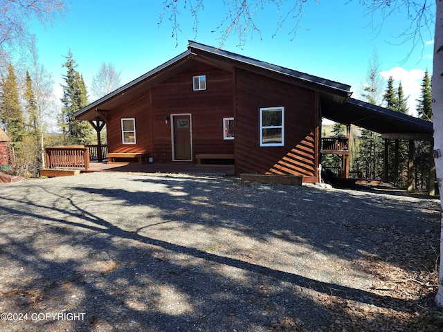 back of house with a wooden deck