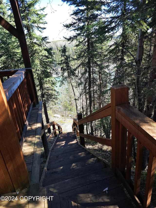 wooden deck with a view of trees