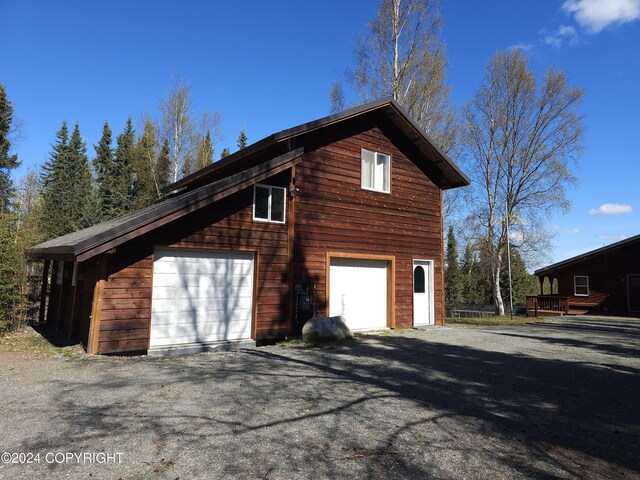 view of side of property with a detached garage