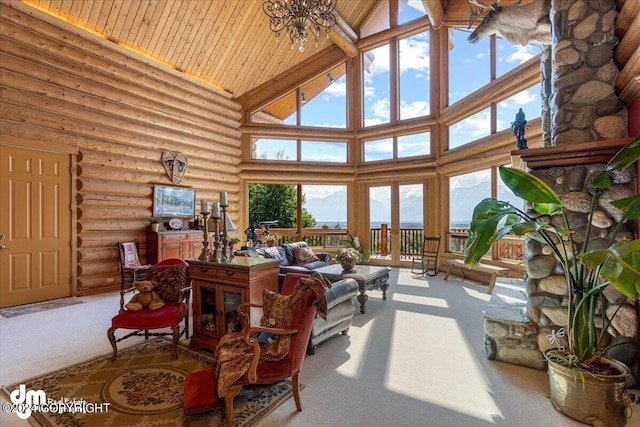 sunroom featuring vaulted ceiling, wood ceiling, plenty of natural light, and an inviting chandelier