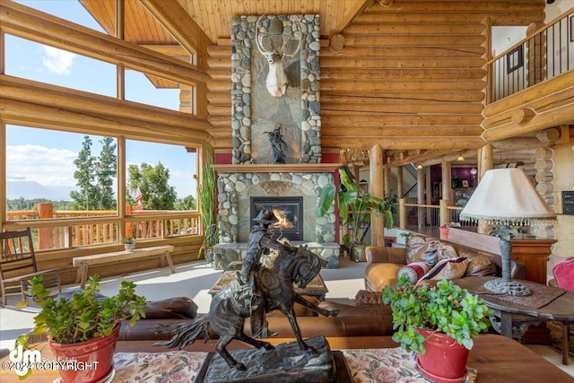 living area with a fireplace and a towering ceiling