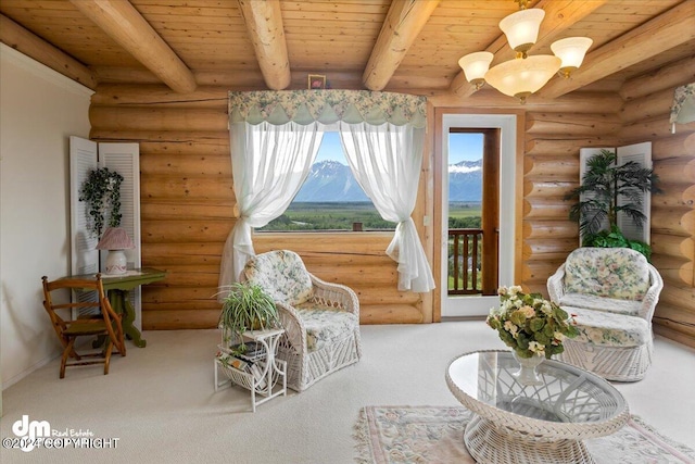 living area featuring wood ceiling, carpet floors, a chandelier, a mountain view, and beam ceiling