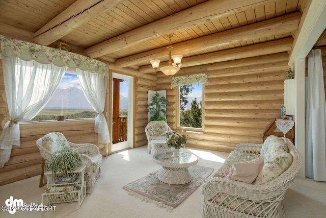 living area featuring beamed ceiling, carpet flooring, wood ceiling, and an inviting chandelier