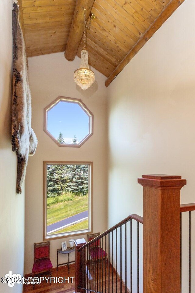 staircase featuring wooden ceiling, high vaulted ceiling, and beam ceiling