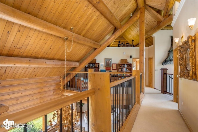 corridor with carpet floors, vaulted ceiling with beams, rustic walls, wood ceiling, and an upstairs landing