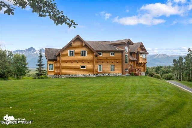 rear view of house featuring a yard, crawl space, and a mountain view