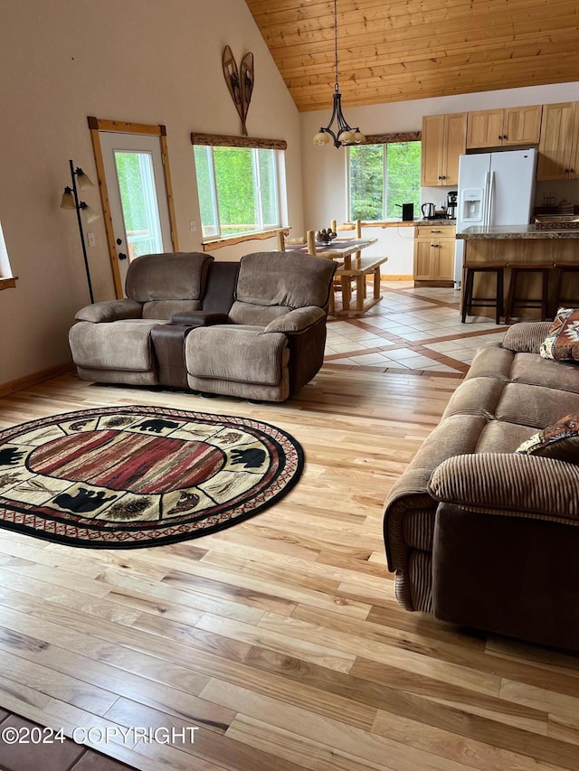 living area with wooden ceiling, light wood-style flooring, high vaulted ceiling, and baseboards