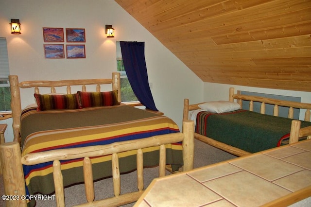 bedroom featuring vaulted ceiling and wooden ceiling