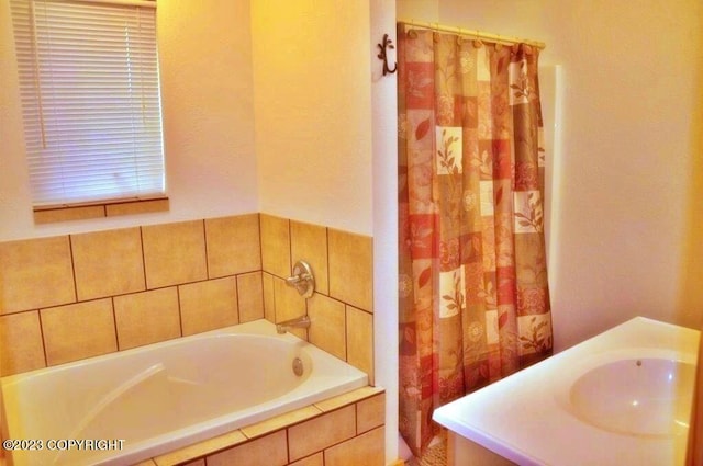 bathroom with a sink, a bath, and a shower with curtain