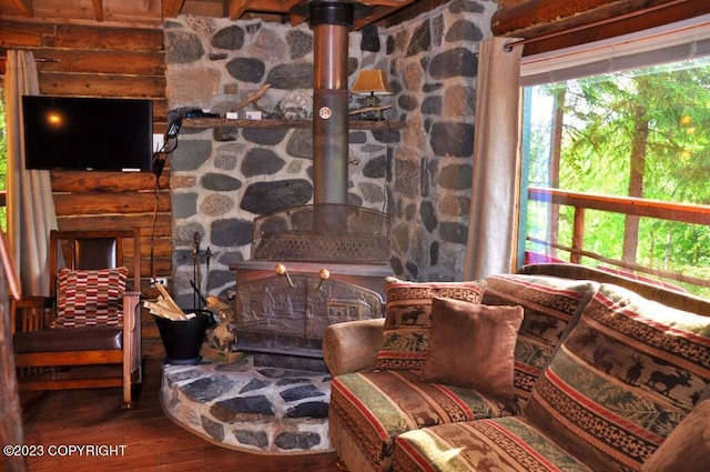 living area featuring wood finished floors and a wood stove