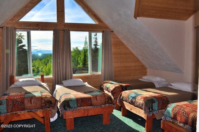 bedroom featuring vaulted ceiling and wooden walls