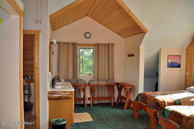 bedroom featuring lofted ceiling, dark carpet, a sink, and wooden ceiling