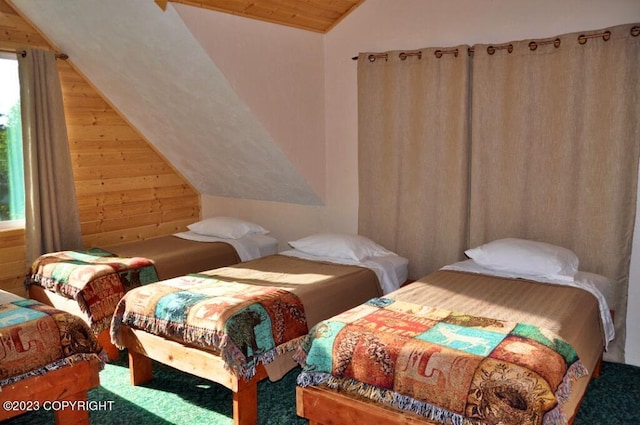 bedroom featuring wood ceiling, vaulted ceiling, and wood walls