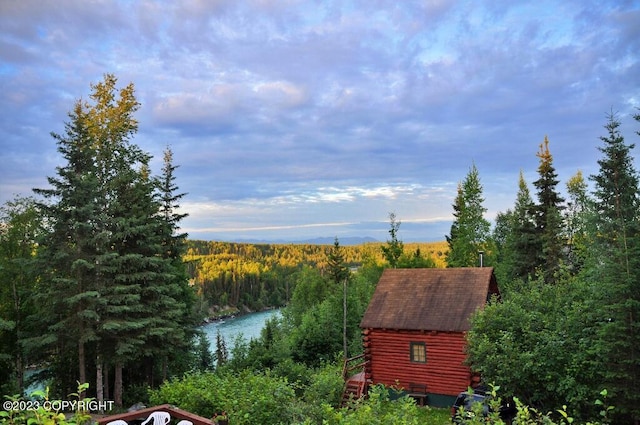 exterior space featuring a forest view