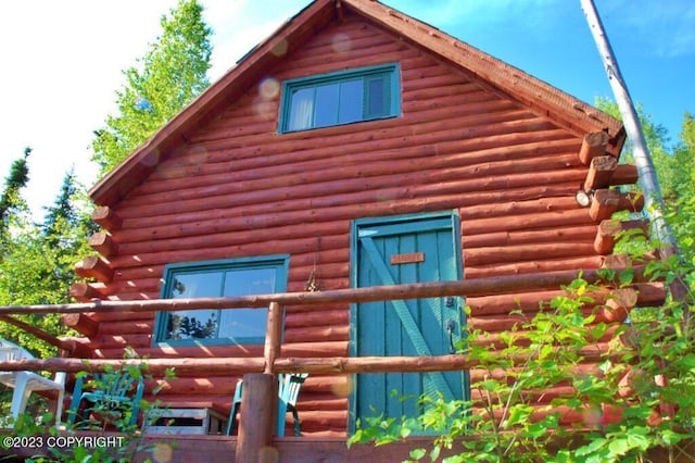 view of side of home with log siding