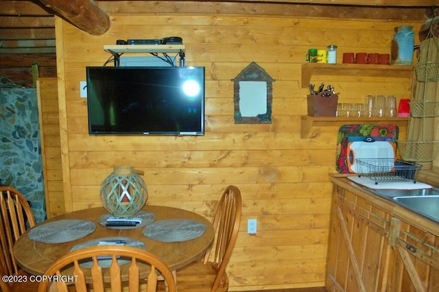 dining space featuring wood walls