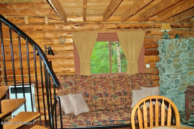 interior space with beam ceiling, wooden ceiling, and log walls