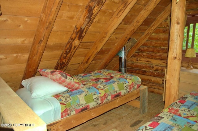 bedroom with lofted ceiling and wood walls