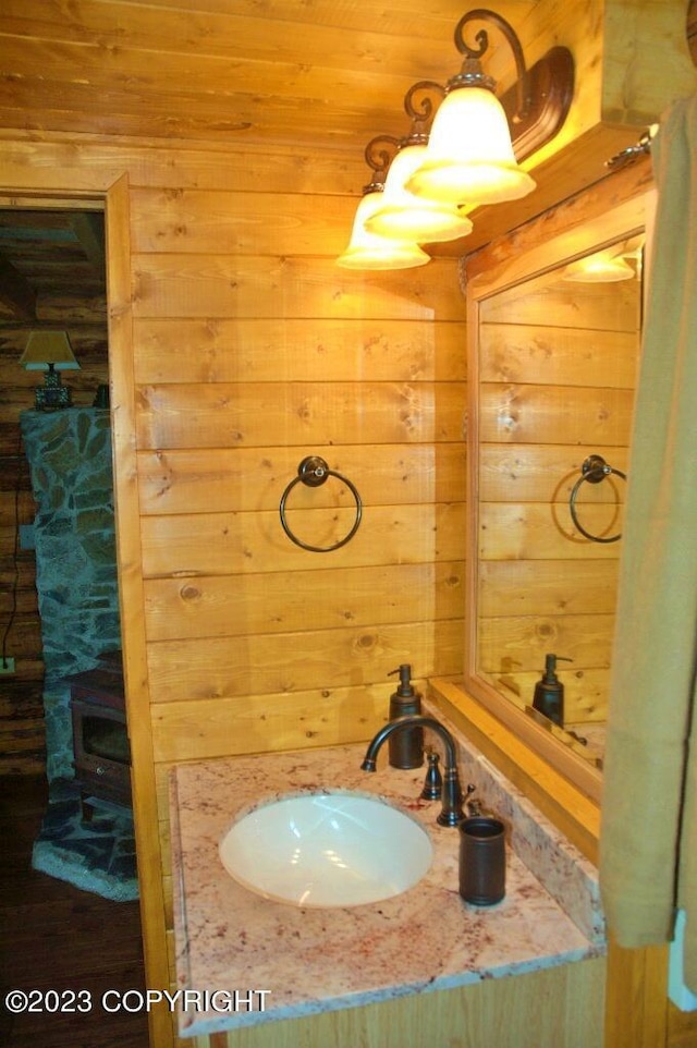 bathroom with a sink and wooden walls