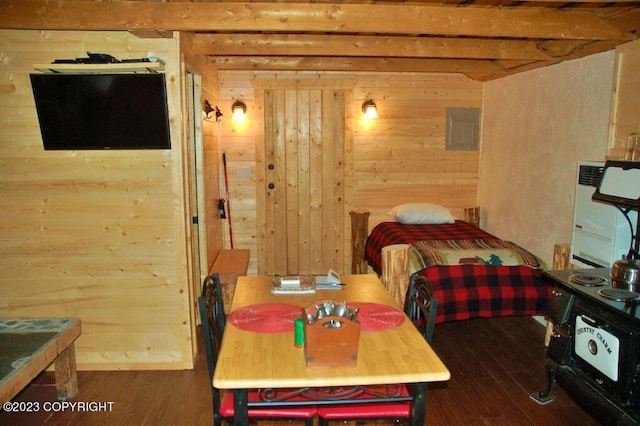 bedroom featuring wooden walls and wood finished floors