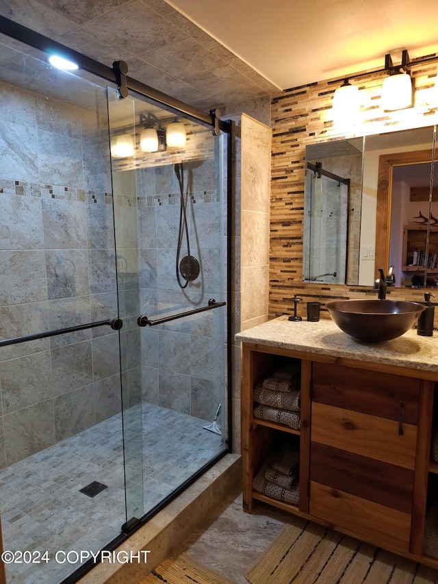 full bath with a shower stall and vanity