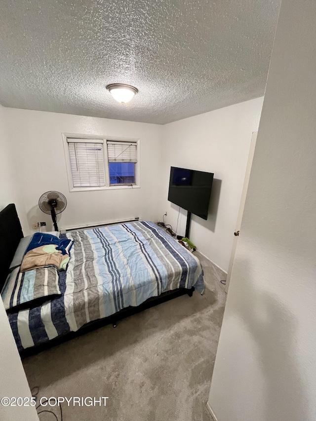 bedroom with a textured ceiling and carpet floors