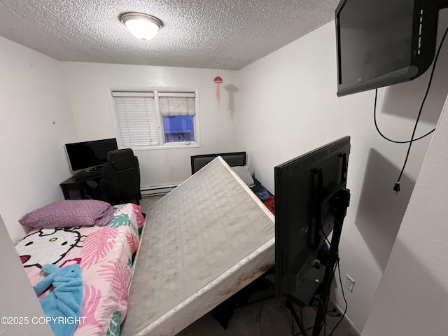 bedroom featuring a textured ceiling and baseboard heating