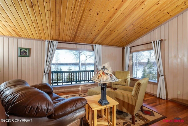 sitting room featuring a water view, wood finished floors, wooden walls, lofted ceiling, and wood ceiling