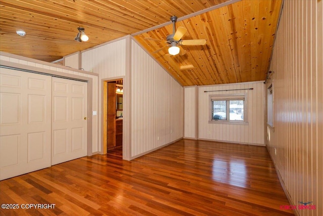 additional living space with wood finished floors, baseboards, ceiling fan, vaulted ceiling, and wooden ceiling