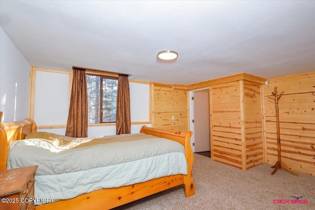 carpeted bedroom with wood walls